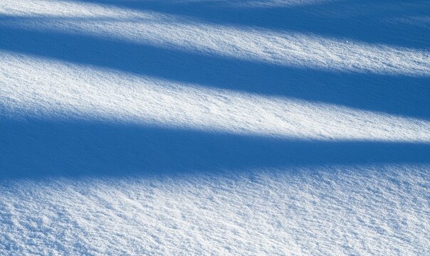 Textured snowfield with diagonal shadows cast by unseen objects