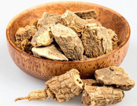 Fresh slices of Butea superba root in a wooden bowl, featuring a natural textured medicinal herb, organic traditional remedy, healthy plant extract, alternative wellness ingredient, botanical