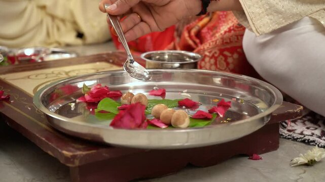 Colorful Indian ritual Celebration worshiping during pooja & offering flowers and rose petals