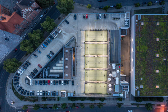 Aerial view of the Victoria-Center rooftop featuring illuminated padel courts and a parking area in Berlin, Berlin, Germany.