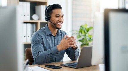 Fototapeta premium Smiling businessman and consultant using a headset for communication and online advice at his office desk.