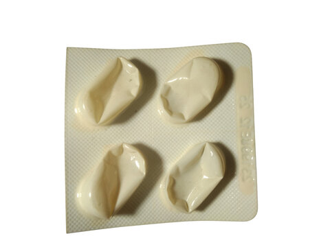 Four white pills in a small square plastic blister pack isolated on transparent background
