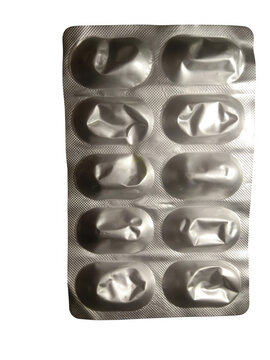 Empty silver foil blister pack with ten used pill compartments isolated on transparent background