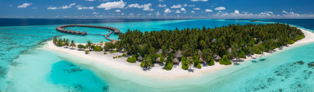 Outstanding Maldives aerial panorama tropical island luxury resort water bungalows turquoise lagoon white sand beach palm trees ocean coral reef summer vacation paradise landscape scenic drone view