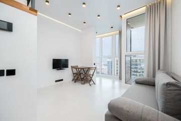Fototapeta premium Folding wooden table and chairs in bright living area