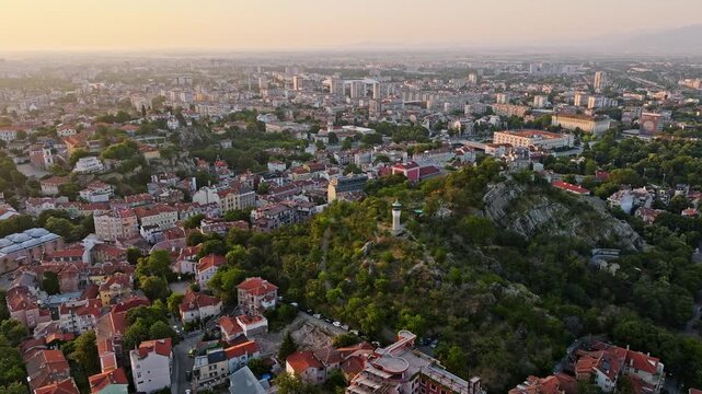 Plovdiv Sahat Tepe clock tower aerial drone view city skyline golden sunrise light ancient town hills historic landmark summer travel destination Bulgaria