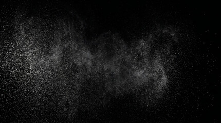 Obraz premium Fine white dust particles bursting against a solid black background creating dynamic texture