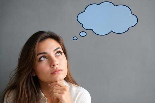 A young woman with long brown hair is looking upwards thoughtfully against a plain gray background, with a thought bubble above her head.