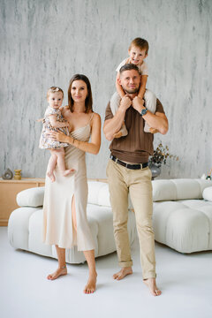 Family Standing Together in Bright Living Room