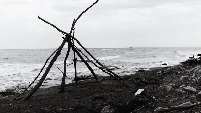A single-person teepee on a sandy beach, perfect for camping or relaxation