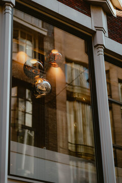 Elegant light fixtures reflected in a shop window