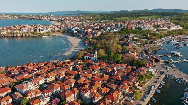 Sozopol old town aerial drone view terracotta roofs traditional wooden architecture sandy beach marina harbour sunset light summer travel destination Bulgaria