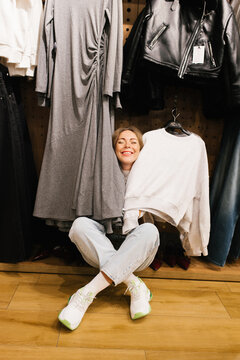 Customer Sitting on Floor with Fashion Clothes