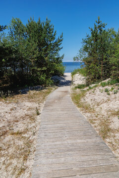 Wooden boardwalk through coastal dunes to Jaunkemeri beach in Jurmala, Latvia