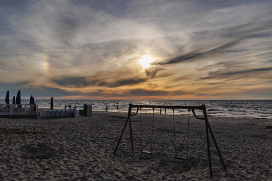 Swings on sandy beach with sea view during sunset in Majori in Jurmala, Latvia