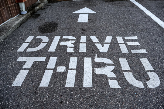 Drive through with arrow sign on asphalt 