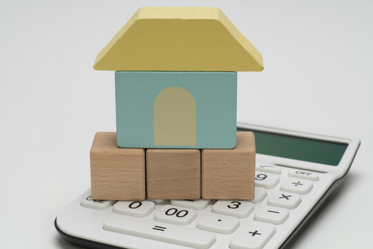 住宅模型と3文字用木製ブロックの住宅資金イメージ