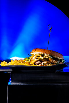 Gourmet angus burger with brioche bun, melted cheese, bacon, and gorgonzola