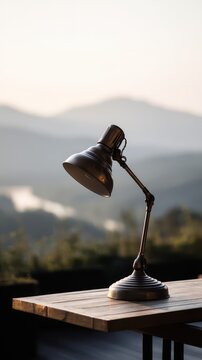 Vintage desk lamp on a wooden table outdoors.