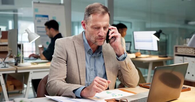 Laptop, man and phone call in office with paperwork, communication and accounting analysis chart. Tech, talk and mature person with financial document for tax evaluation, cost data and coworking