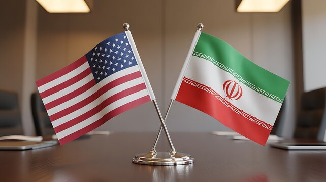 Small desk flags of two different countries placed together on a table in a meeting room setting for diplomacy discussion