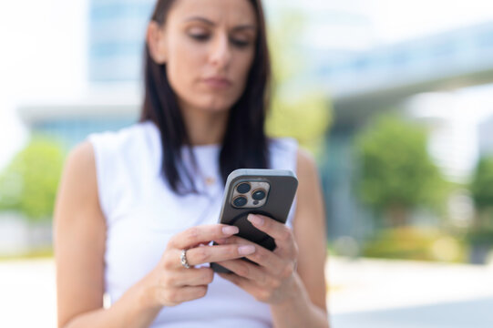 Woman using smartphone outdoors connecting with technology