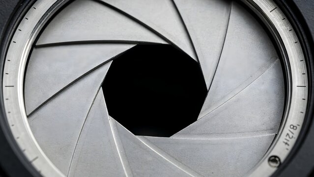 Close up of metallic camera lens aperture blades in circular shape &ndash; Great for photography equipment, aperture control, camera gear, or optics.