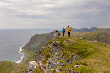 Fototapeta premium Mount Matind hike, family with children and pet dog, hiking Matinden peak summertime