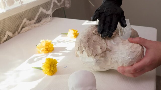 Handmade papier-mache calavera skull in progress for Dia de los Muertos DIY decor