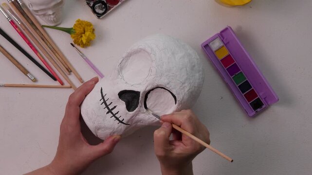 Handmade papier-m&acirc;ch&eacute; calavera skull painting in Day of the Dead inspired craft process