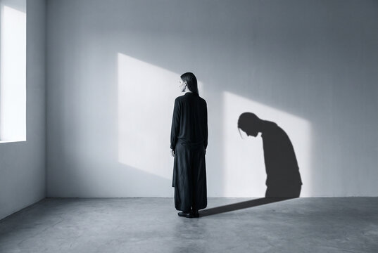 Silhouette Woman in Minimalist Room with Dramatic Shadow and Light