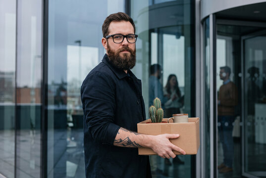 Laid off employee leaving office with personal belongings