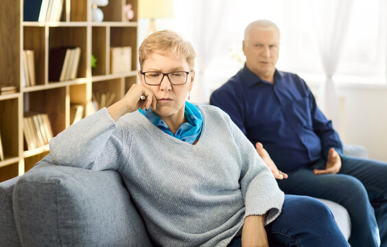 Senior couple in conflict, upset and stress. Older partners argue at home, showing relationship strain and poor communication, fueling resentment. Concept of marital tension and anxiety.