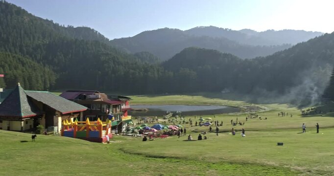 Wide Ground Level Pan of Khajjiar with Nag Temple, Green Meadow, Lake and Cedar Pine Forests in Chamba Himachal Pradesh India