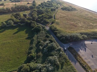 Aerial drone 4K view of Leasowe beach dunes and surrounding greenland in warm sunlight Leasowe Wirral © Wirral Views