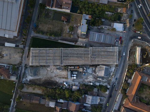 Aerial view of the construction of the Solo-Yogyakarta Toll Road showing concrete beams and heavy machinery at the site in Kecamatan Depok, Daerah Istimewa Yogya, Indonesia.