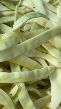 Fresh sliced Romano beans displayed at local farmers market with green flat bean strips prepared for home cooking and seasonal healthy meals
