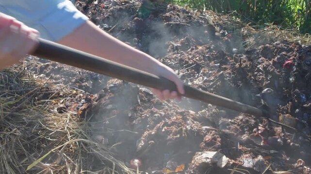 Turning organic waste windrow for aerobic decomposition at composting facility