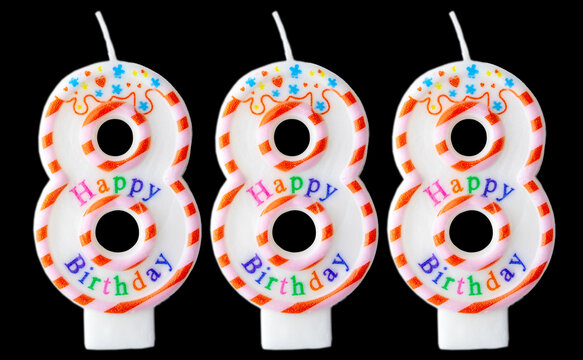 Number eight hundred eighty-eight shaped birthday candles with colorful sprinkles and Happy Birthday text isolated on a black background