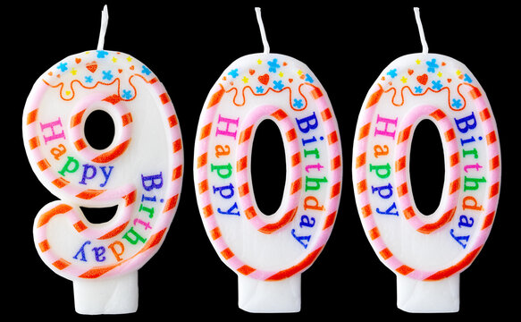 Number nine hundred shaped birthday candles with colorful sprinkles and Happy Birthday text isolated on a black background