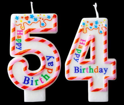 Number fifty four shaped birthday candle with colorful sprinkles and Happy Birthday text isolated on a black background