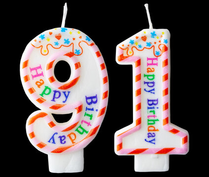 Number ninety-one shaped birthday candle with colorful sprinkles and Happy Birthday text isolated on a black background