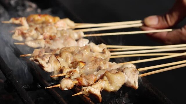Satay, a famous Indonesian dish, with skewered meat grilled over hot charcoal to create a smoky flavor. This popular street food is often served with peanut sauce and traditional spices.