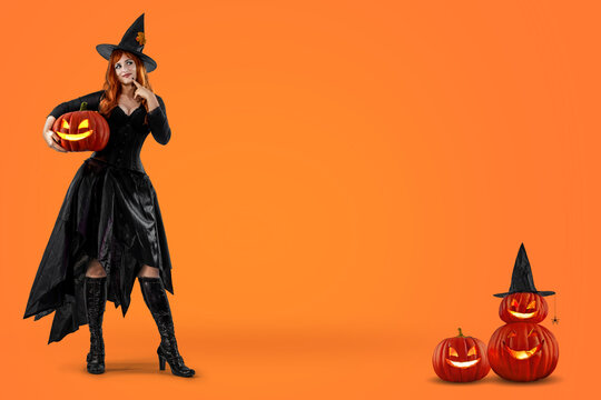 Witch on Halloween. Female wizard fairy character for All Saints' Day. Fantasy gothic red-haired Vampire girl in black dress. Enchantress dressed in carnival costume