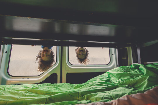 Children, having fun in motorhome while heavy raining outdoors, playing and making mischiefs together