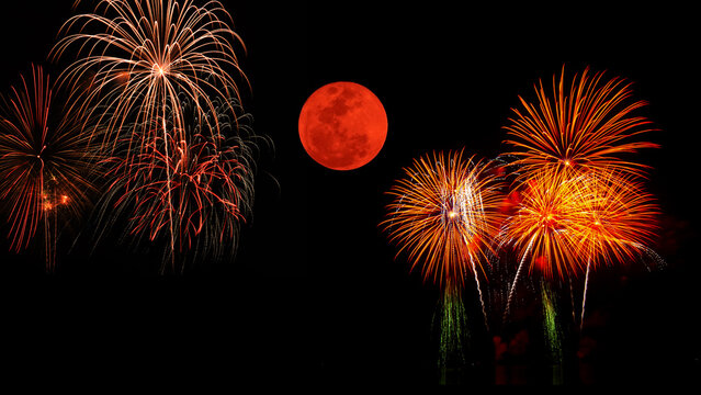 Festival fireworks against a blood moon background. 