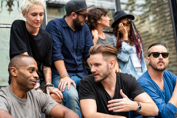 Obraz premium Diverse group enjoying conversation outdoors.