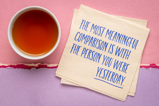 The Most Meaningful Comparison Is With the Person You Were Yesterday. Inspirational handwritten message on a napkin with coffee, promoting self-improvement, progress, confidence, and personal growth.