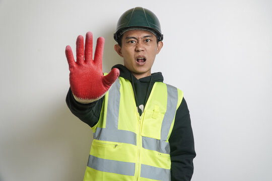 Angry Construction Worker in Safety Vest and Hard Hat Showing Stop Sign