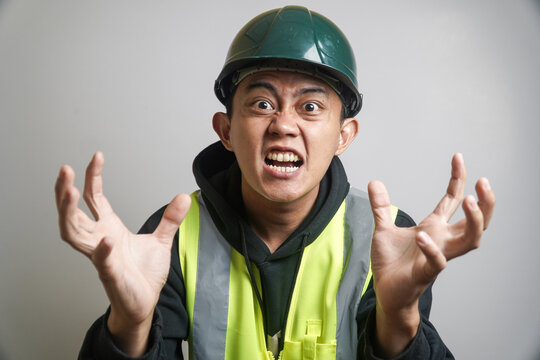 Angry Asian Construction Worker in Hard Hat Expressing Extreme Frustration